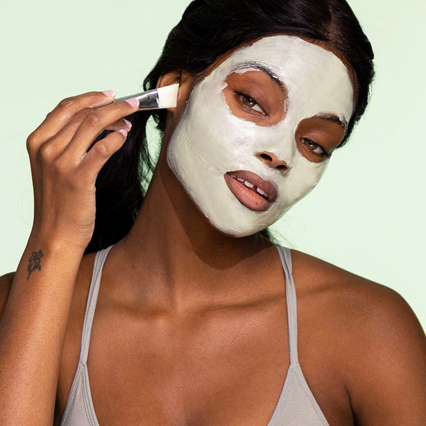 girl putting facial mask for oily skin